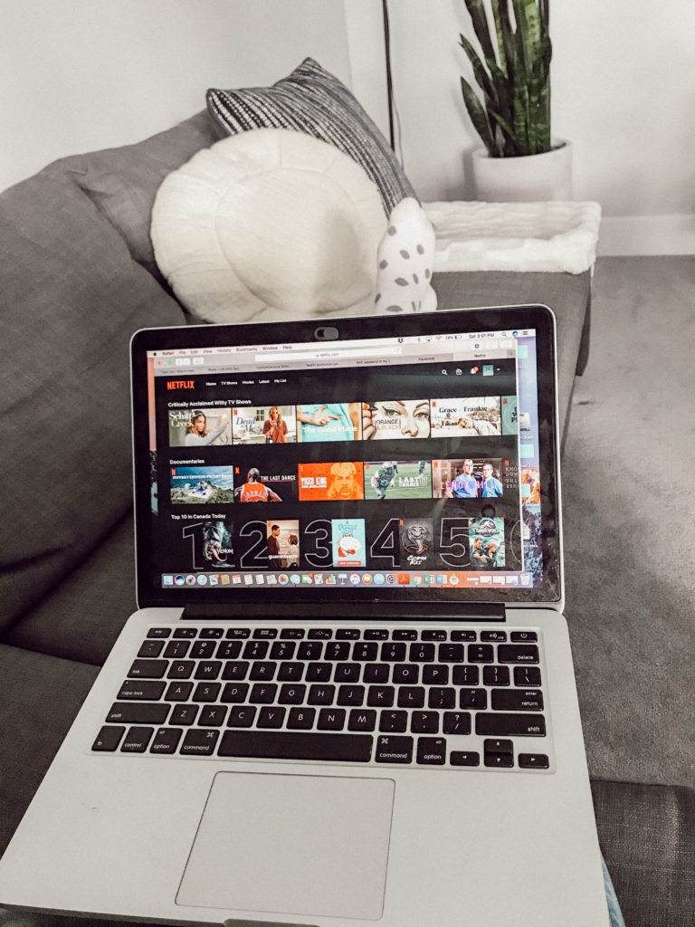 laptop with Netflix on lap